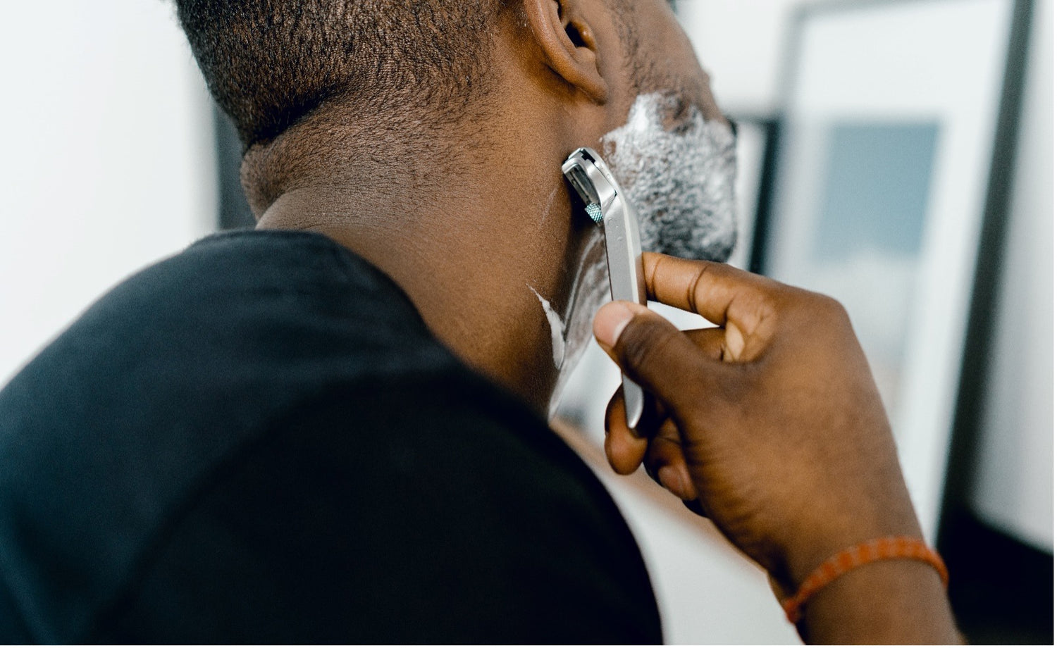 Man shaving face with razor